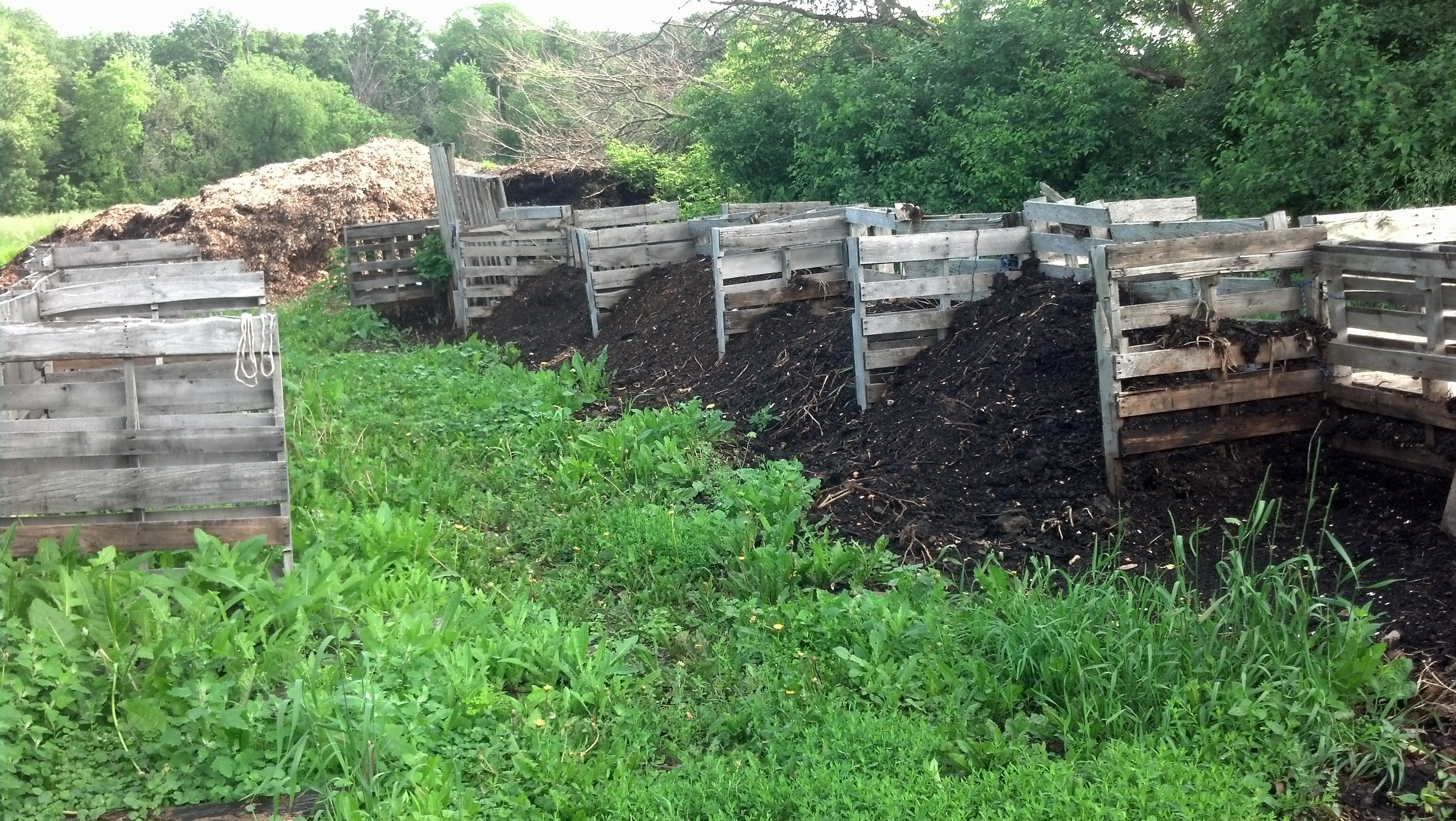 The Full Cycle Freight composting setup. Giant piles of leaf mulch from neighboring Shorewood Hills are in the background.